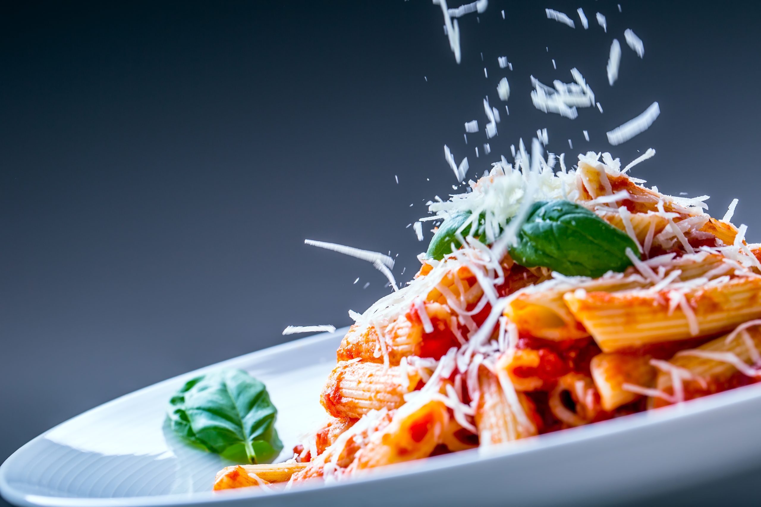 Pasta Penne With Tomato Bolognese Sauce, Parmesan Cheese And Basil.