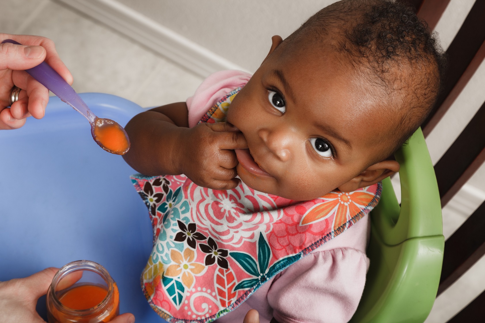 mother feeding adopted baby daughter